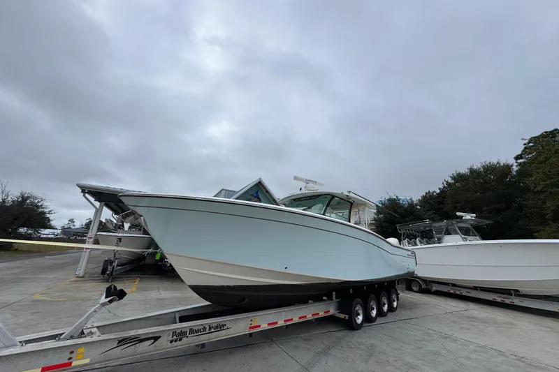  Yacht Photos Pics 2024 Grady-White Canyon 386 boat on trailer under cloudy sky.