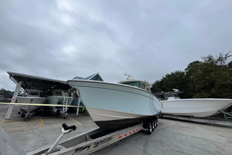  Yacht Photos Pics 2024 Grady-White Canyon 386 boat on trailer, overcast sky background.