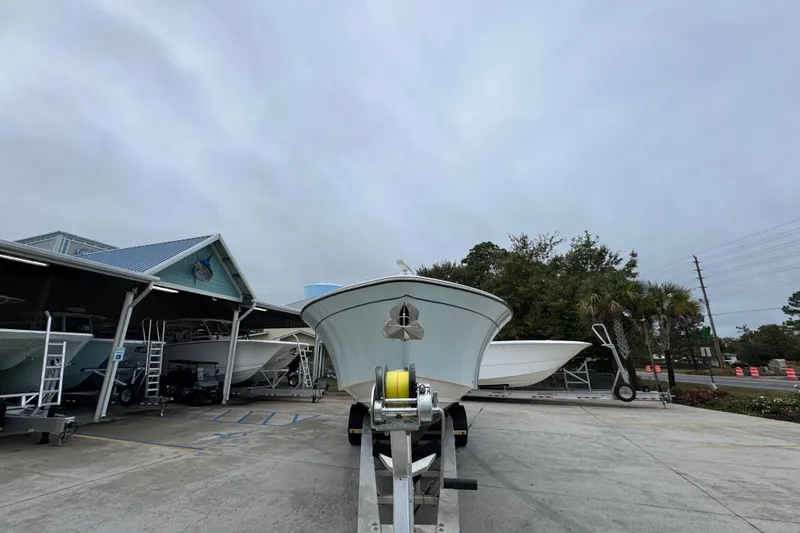  Yacht Photos Pics 2024 Grady-White Canyon 386 boat on trailer at dealership, overcast sky.