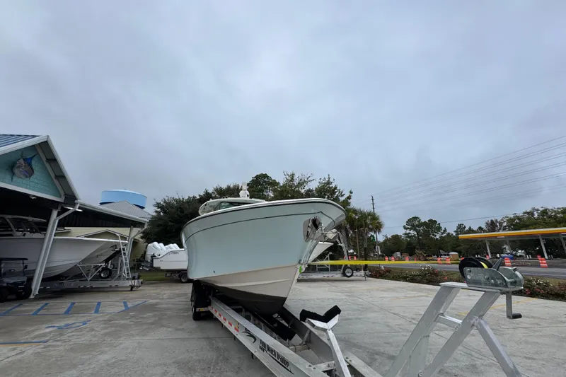  Yacht Photos Pics 2024 Grady-White Canyon 386 boat on trailer in parking lot, overcast sky.