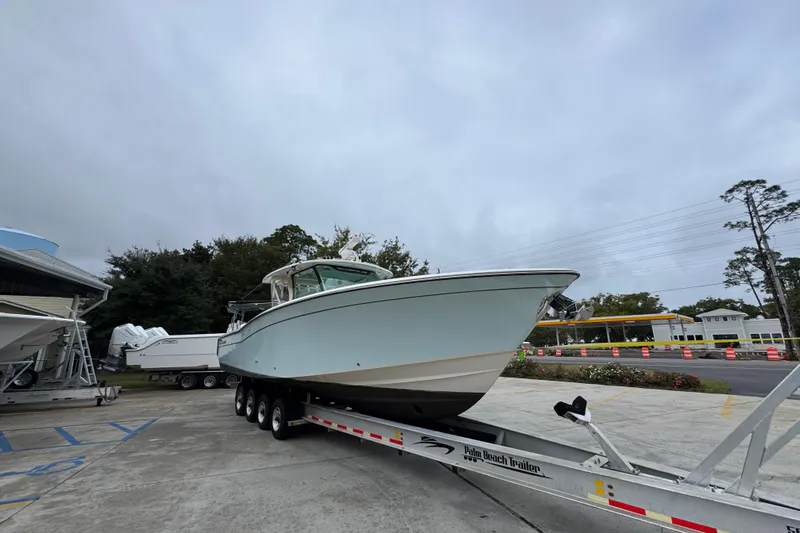  Yacht Photos Pics 2024 Grady-White Canyon 386 boat on trailer, parked outdoors.