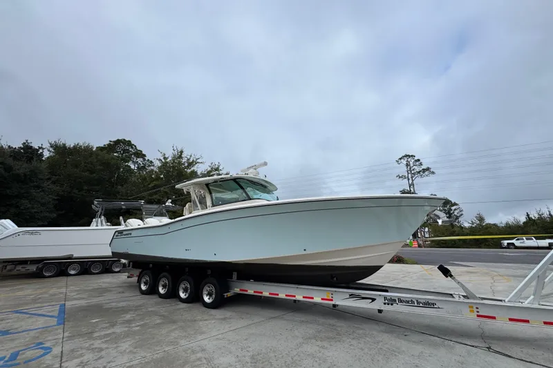  Yacht Photos Pics 2024 Grady-White Canyon 386 boat on trailer, parked outdoors.