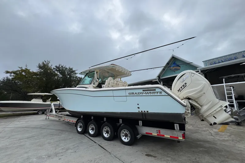  Yacht Photos Pics 2024 Grady-White Canyon 386 boat on trailer, overcast sky background.