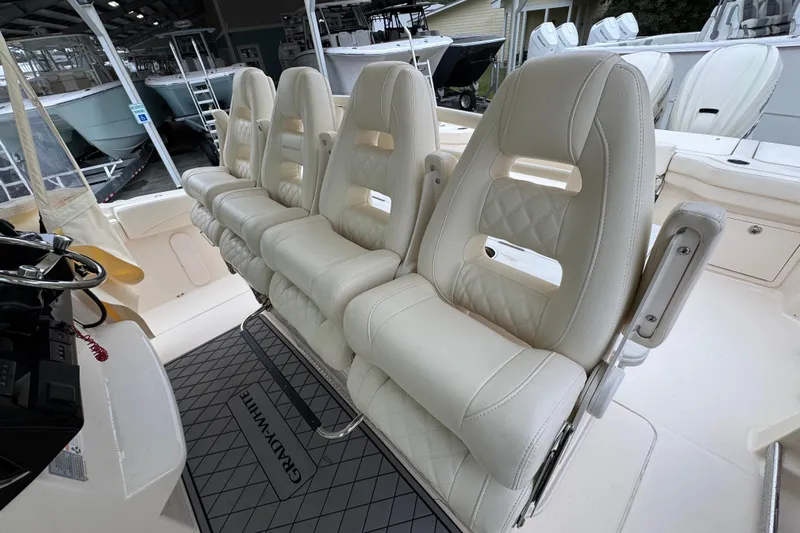  Yacht Photos Pics 2024 Grady-White Canyon 386 boat interior with luxurious white seating and helm.