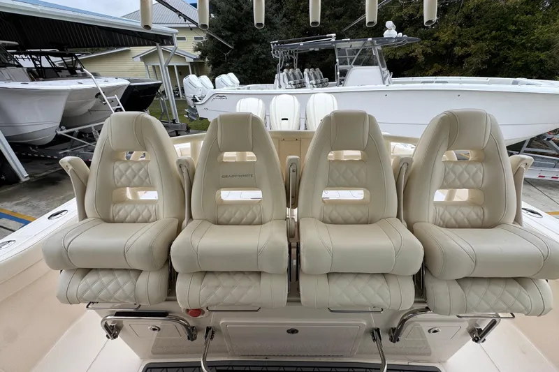  Yacht Photos Pics Luxurious seating on 2024 Grady-White Canyon 386 boat, featuring plush, cream-colored upholstery.