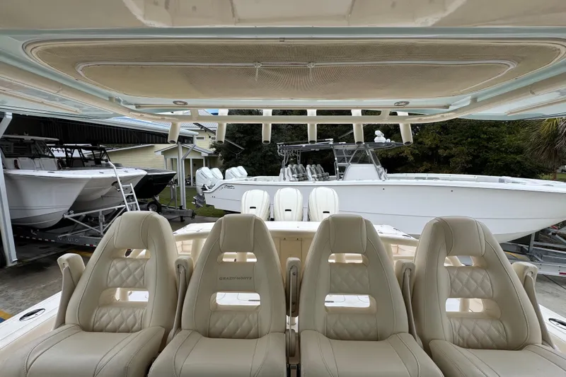  Yacht Photos Pics 2024 Grady-White Canyon 386 boat interior with luxurious seating and helm view.