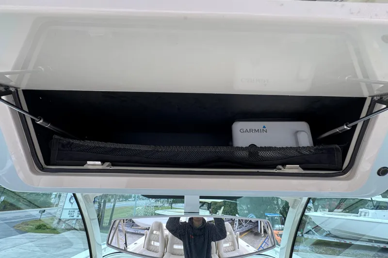  Yacht Photos Pics 2024 Grady-White Canyon 386 storage compartment with Garmin equipment inside.