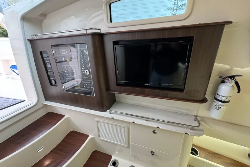 Yacht Photos Pics 2024 Grady-White Canyon 386 interior with control panel, TV, and fire extinguisher.