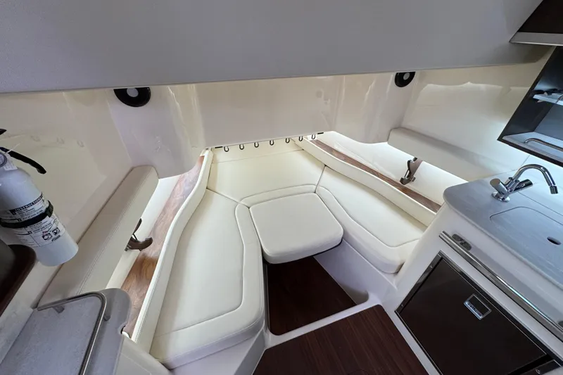  Yacht Photos Pics 2024 Grady-White Canyon 386 interior with seating, kitchenette, and fire extinguisher.