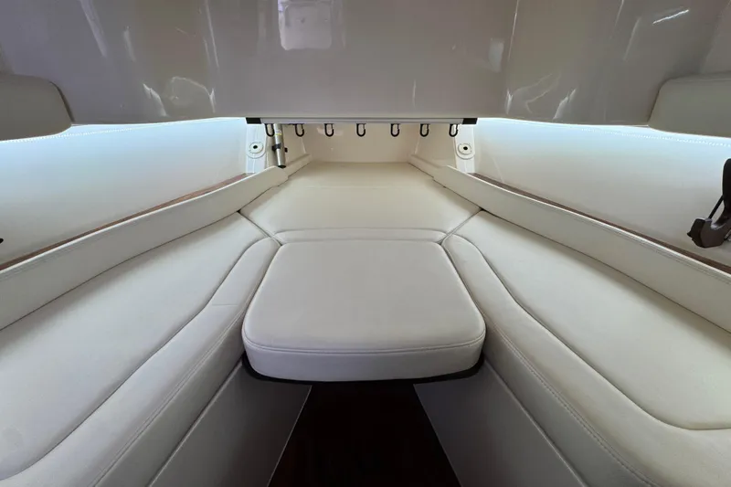  Yacht Photos Pics 2024 Grady-White Canyon 386 interior with white cushioned seating and sleek design.