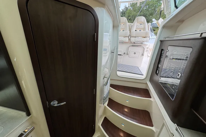  Yacht Photos Pics 2024 Grady-White Canyon 386 interior with wooden door, steps, and control panel.