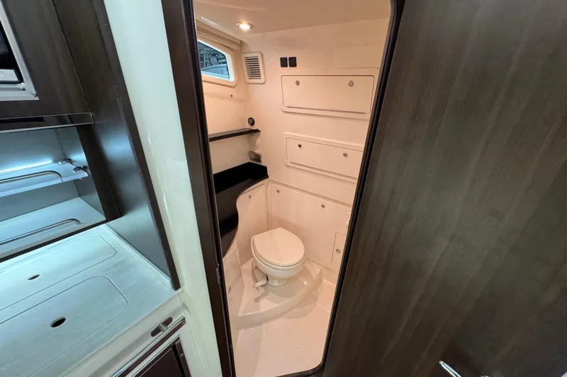  Yacht Photos Pics 2024 Grady-White Canyon 386 boat interior bathroom with modern fixtures and storage.