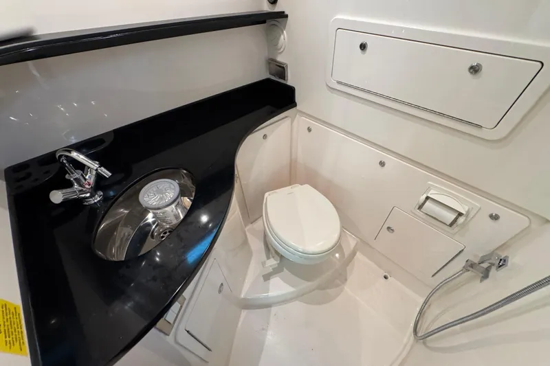  Yacht Photos Pics 2024 Grady-White Canyon 386 boat bathroom with sink, toilet, and storage compartments.