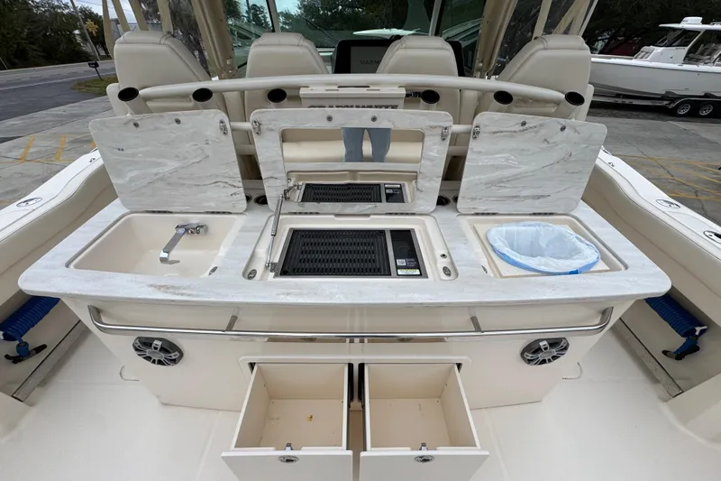  Yacht Photos Pics 2024 Grady-White Canyon 386 boat with open storage compartments and seating area.