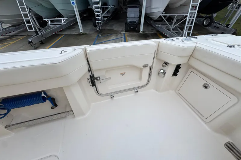  Yacht Photos Pics 2024 Grady-White Canyon 386 boat interior with storage compartments and coiled hose.