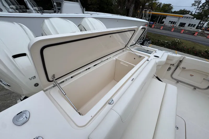  Yacht Photos Pics 2024 Grady-White Canyon 386 boat with open storage compartment, showcasing spacious design.