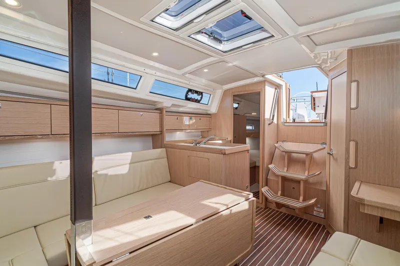 New Sailboat Yacht Photos Pics Modern interior of 2024 Bavaria Cruiser 34 sailboat with light wood finish and ample natural light.