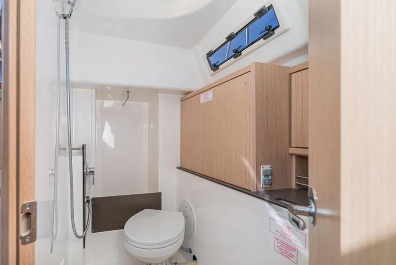 New Sailboat Yacht Photos Pics 2024 Bavaria Cruiser 34 bathroom with modern fixtures and wooden cabinetry.