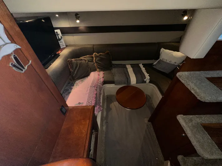  Yacht Photos Pics 2005 Cruisers Yachts 340 Express interior with cozy seating and wooden accents.