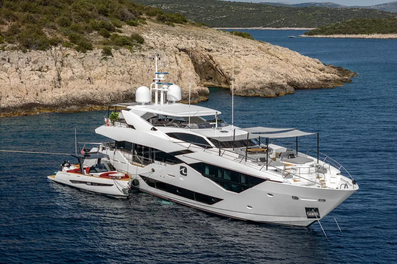 Noroader Yacht Photos Pics Luxurious 2020 Sunseeker 116 yacht anchored near rocky coastline.