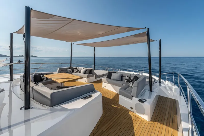 Noroader Yacht Photos Pics Luxurious Sunseeker 116 yacht deck with shaded seating, overlooking serene ocean views.