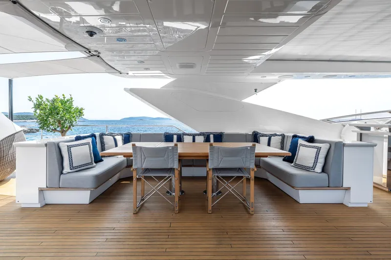 Noroader Yacht Photos Pics Luxurious Sunseeker 116 yacht deck with elegant seating, dining table, and ocean view, 2020 model.