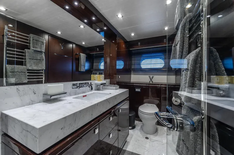 Noroader Yacht Photos Pics Luxurious bathroom on 2020 Sunseeker 116 yacht with marble countertops and modern fixtures.