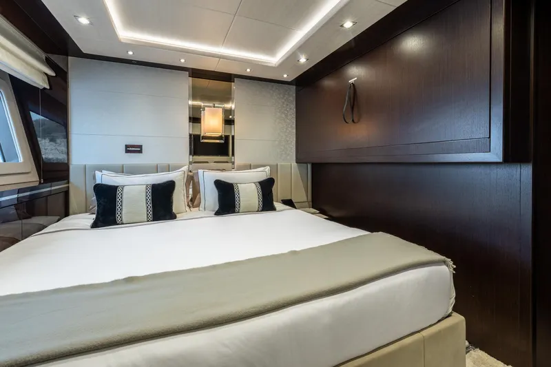 Noroader Yacht Photos Pics Luxurious bedroom interior on 2020 Sunseeker 116 yacht, featuring elegant bedding and modern design.