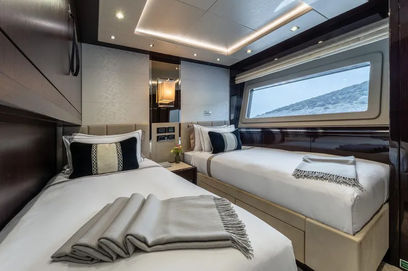 Noroader Yacht Photos Pics Luxurious twin cabin interior on 2020 Sunseeker 116 yacht, featuring elegant bedding and scenic window view.