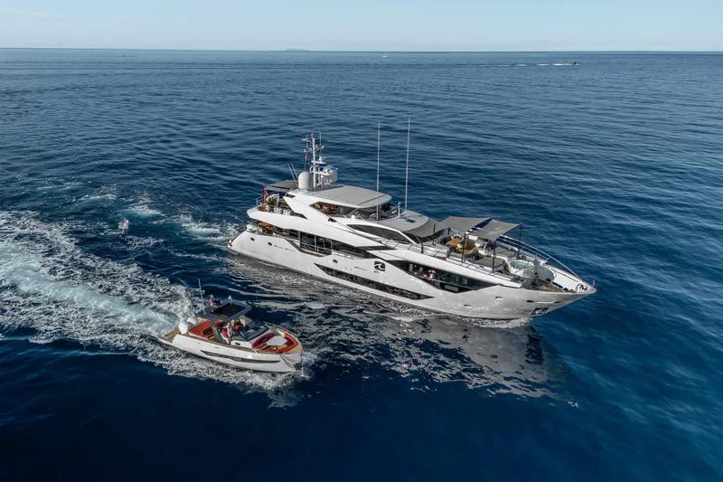 Noroader Yacht Photos Pics Luxurious 2020 Sunseeker 116 yacht cruising with a smaller boat on open sea.