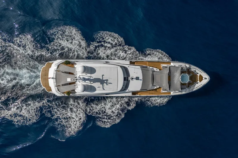 Noroader Yacht Photos Pics Aerial view of 2020 Sunseeker 116 yacht cruising on blue ocean waters.