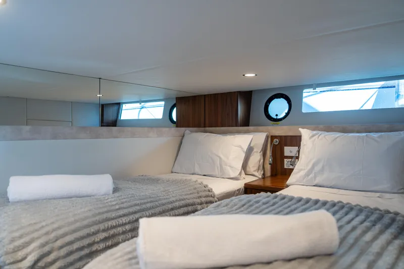  Yacht Photos Pics Luxurious interior cabin of 2022 Riviera 445 SUV yacht with twin beds and modern decor.
