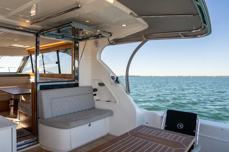  Yacht Photos Pics 2022 Riviera 445 SUV yacht interior with ocean view, featuring seating and dining area.