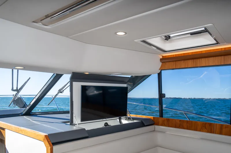  Yacht Photos Pics Interior of 2022 Riviera 445 SUV yacht with TV and ocean view.