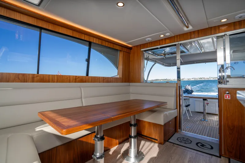  Yacht Photos Pics Luxurious interior of 2022 Riviera 445 SUV yacht with wood accents and ocean view.