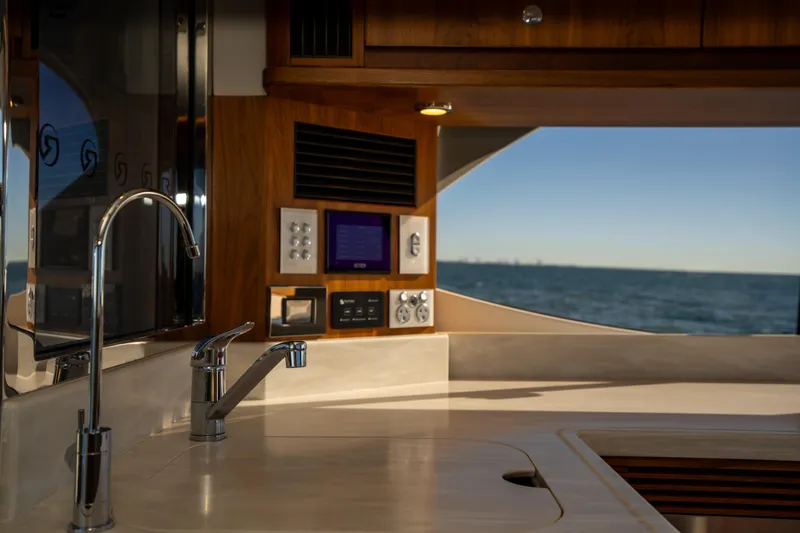  Yacht Photos Pics Interior of 2022 Riviera 445 SUV yacht with ocean view through window.