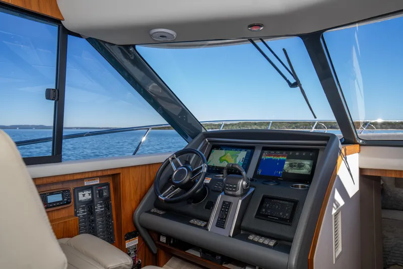  Yacht Photos Pics 2022 Riviera 445 SUV helm with advanced navigation displays and ocean view.