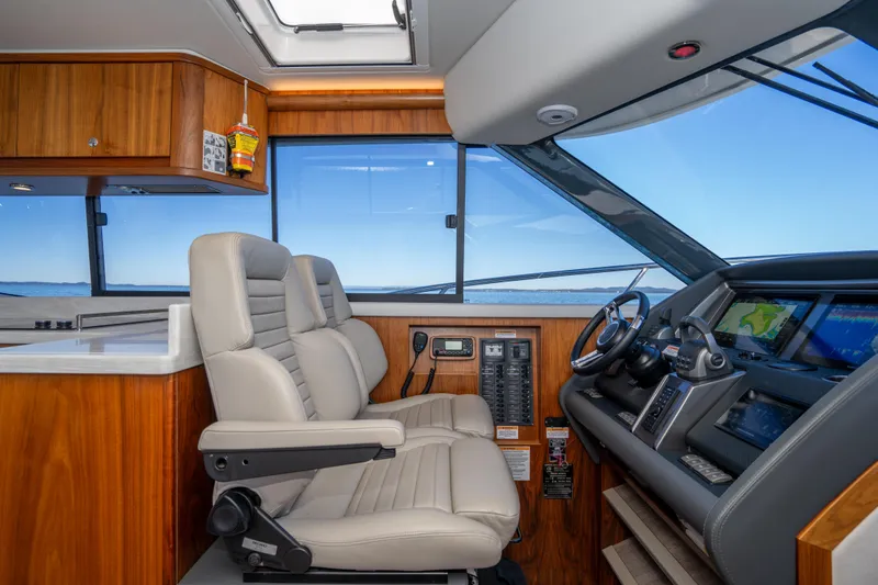  Yacht Photos Pics Interior of 2022 Riviera 445 SUV yacht with modern helm and leather seating.