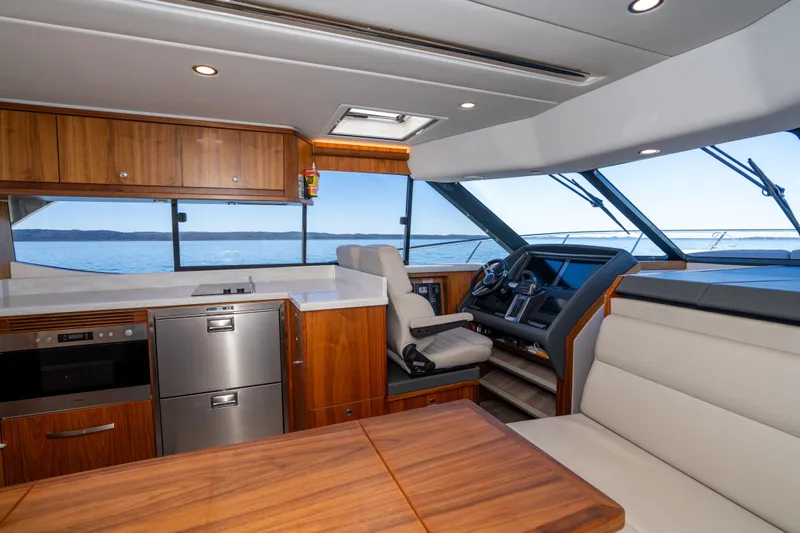  Yacht Photos Pics Interior of 2022 Riviera 445 SUV yacht with modern kitchen and helm.
