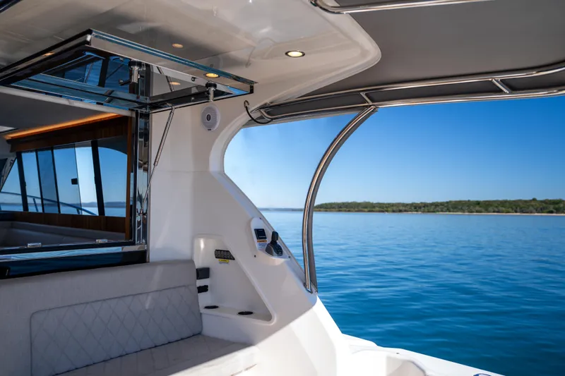  Yacht Photos Pics 2022 Riviera 445 SUV interior with ocean view, featuring sleek design and modern amenities.