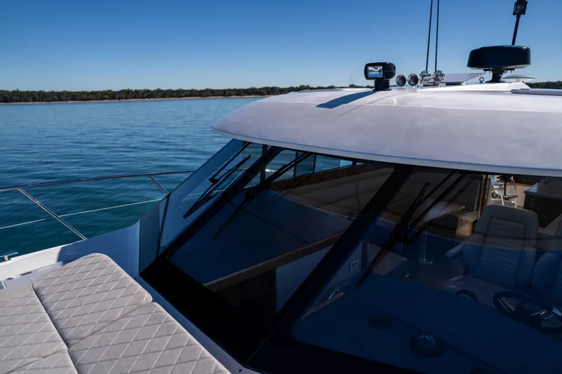  Yacht Photos Pics 2022 Riviera 445 SUV yacht on calm water, showcasing sleek design and luxury features.