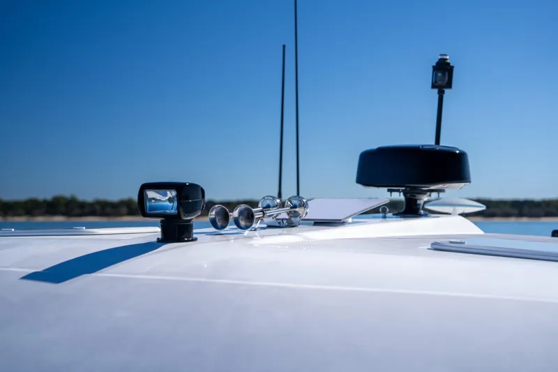  Yacht Photos Pics Riviera 445 SUV 2022 yacht deck with navigation equipment under clear blue sky.