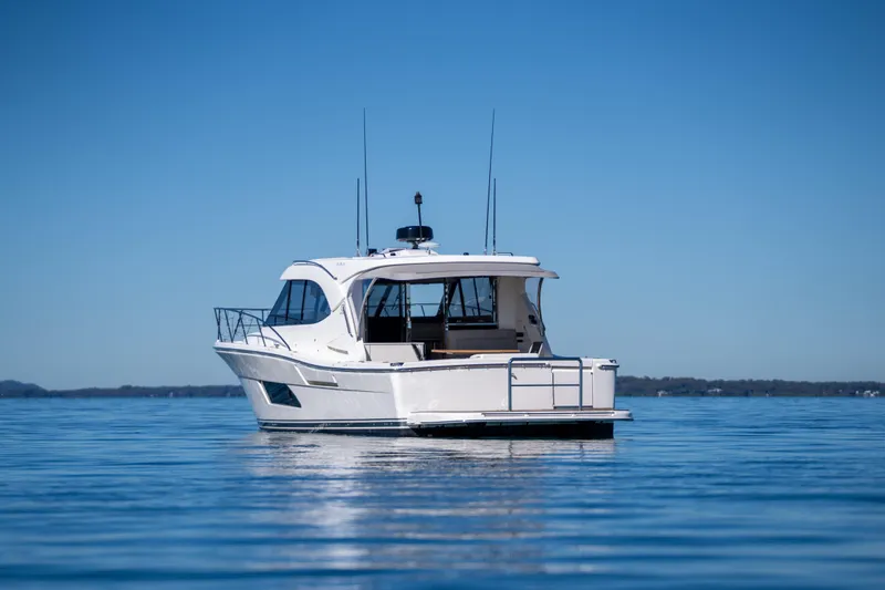  Yacht Photos Pics 2022 Riviera 445 SUV yacht on calm blue water under clear sky.