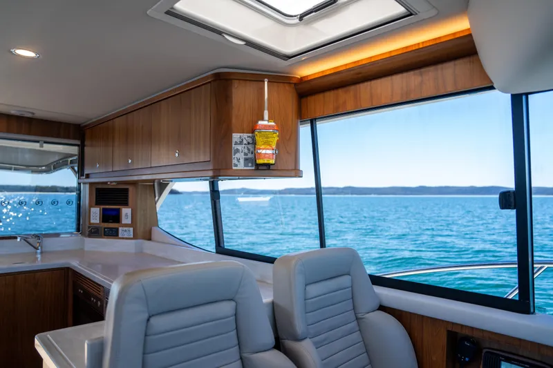  Yacht Photos Pics Interior of 2022 Riviera 445 SUV yacht with ocean view through large windows.