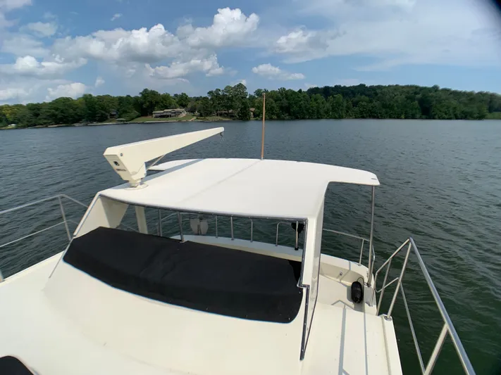Paradise Falls Yacht Photos Pics Harbor Master 520 Coastal 1988 on a serene lake with cloudy sky.