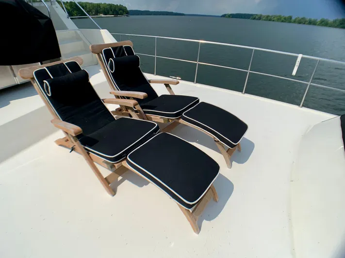 Paradise Falls Yacht Photos Pics Two lounge chairs on 1988 Harbor Master 520 Coastal yacht deck.