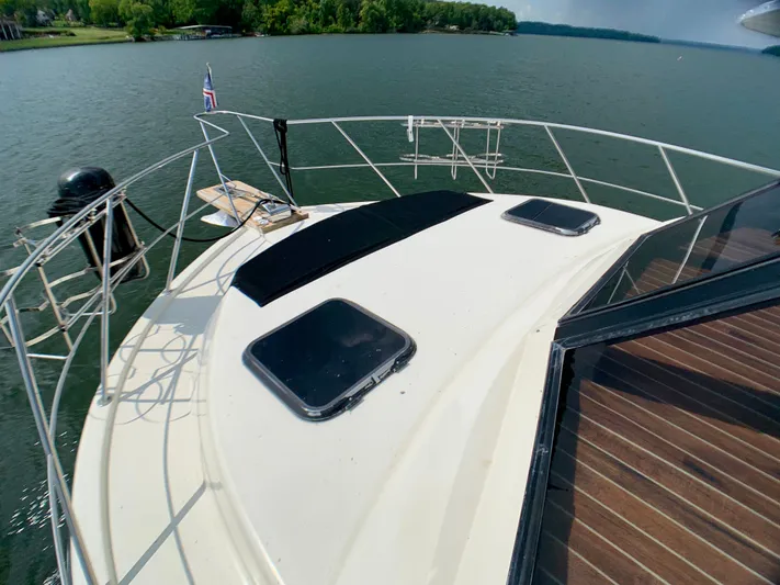 Paradise Falls Yacht Photos Pics Deck of a 1988 Harbor Master 520 Coastal on a serene lake.