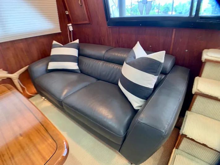 Paradise Falls Yacht Photos Pics Leather sofa with striped pillows in a 1988 Harbor Master 520 Coastal.