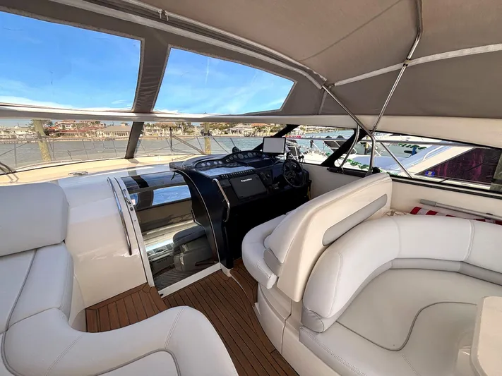 Blind Date Yacht Photos Pics Luxurious 2005 Viking Princess V50 yacht interior with white leather seating and modern helm.