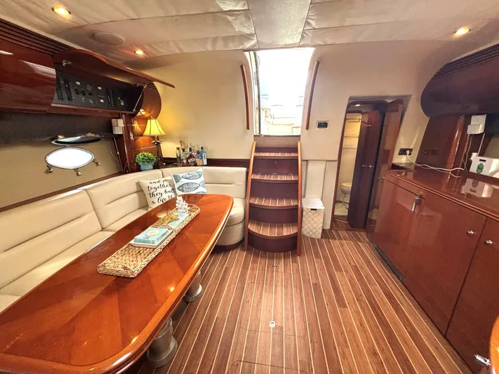 Blind Date Yacht Photos Pics Luxurious 2005 Viking Princess V50 yacht interior with elegant wood finishes and cozy seating area.